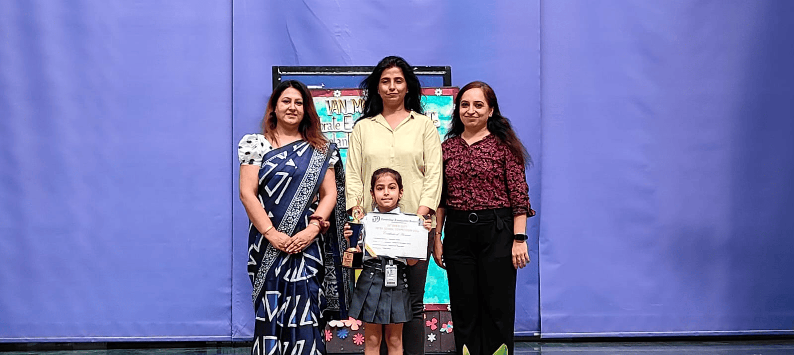 Young achiever holding her appreciation certificate with pride.